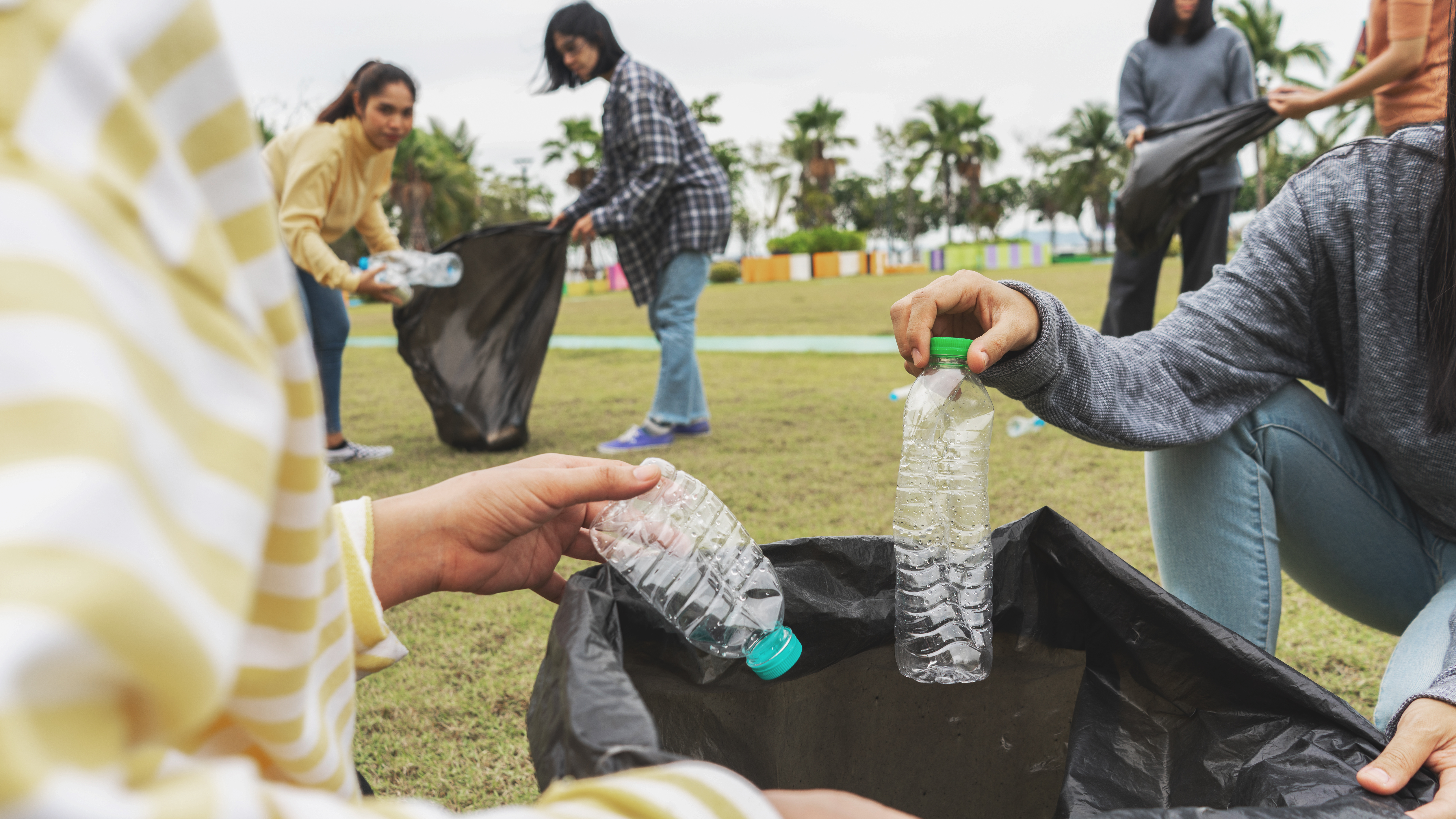 Volunteers clean up trash at a park