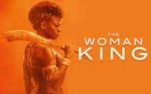 orange background with the image of a warrior tribal woman holding a weapon against an orange background