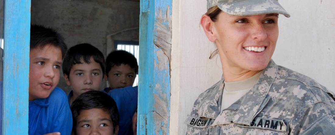 Soldier interacting with school kids