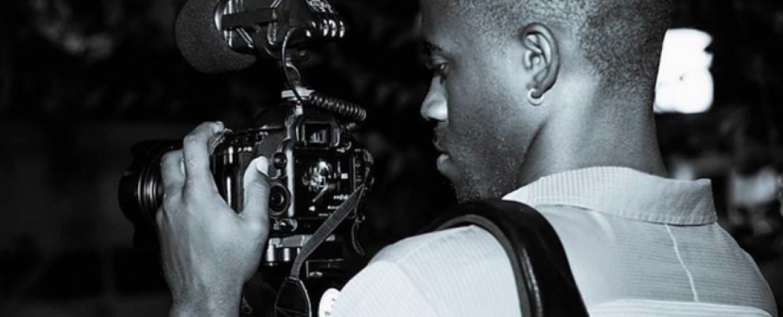 Cornelius Conway holding a camera.