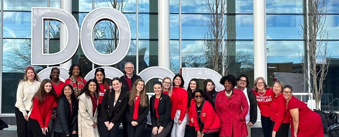 group of students and faculty pose in front of Do Good Sculpture