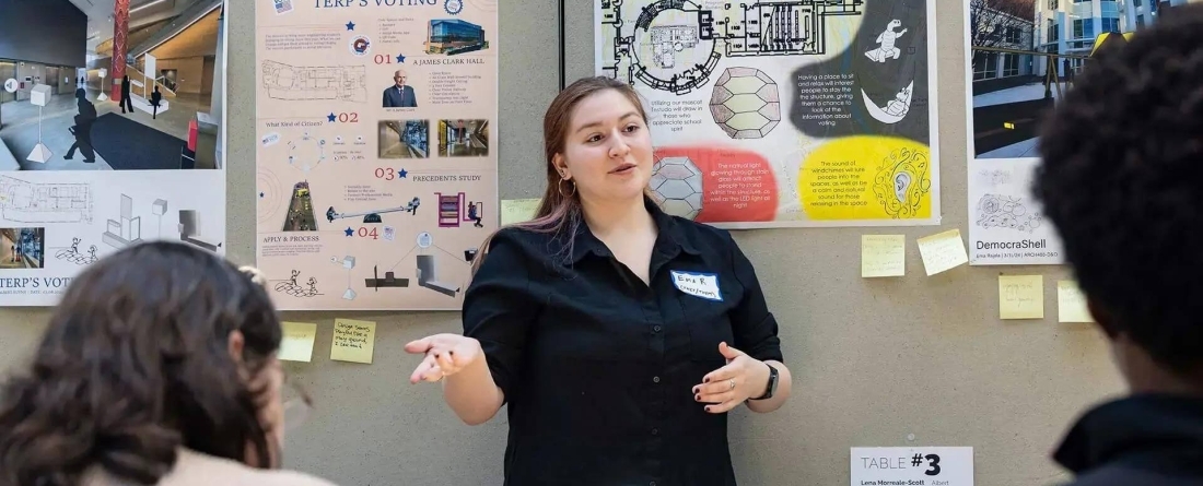 Image of female standing at the front of a classroom presenting