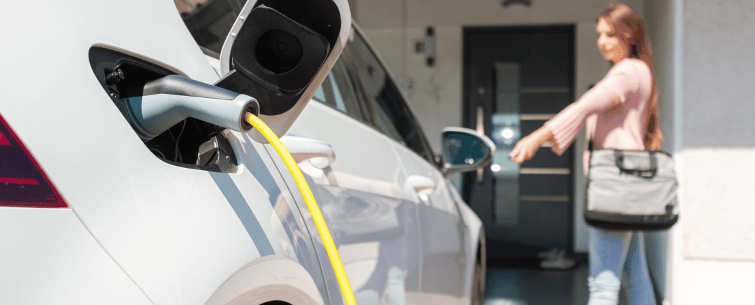 picture of ev car charging in front of a house