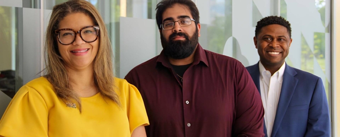 Brandi Slaughter, Maisum Murtaza, Cullen Merritt stand against clear backdrop for a picture