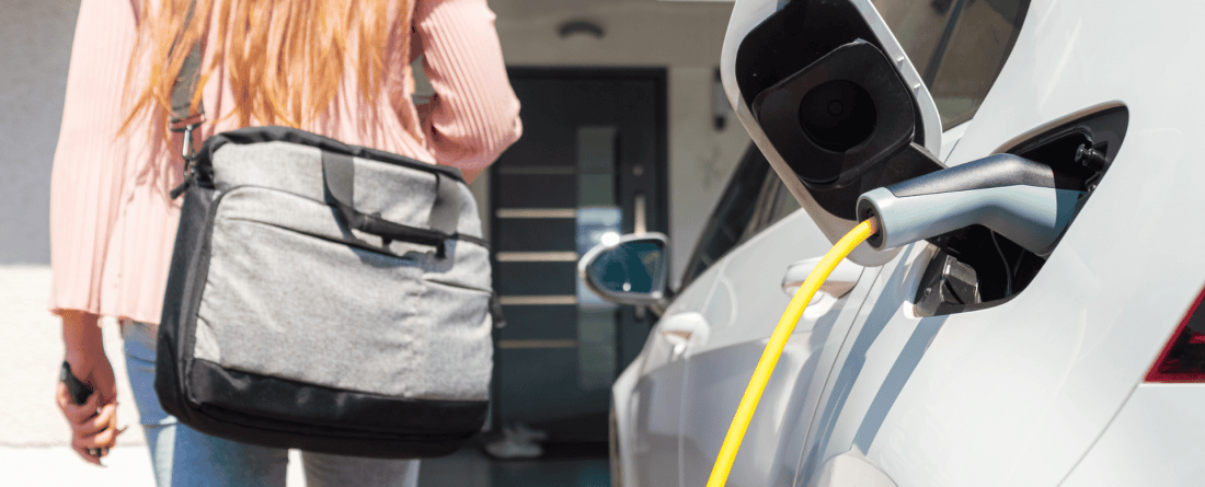 picture of EV car in front of a house with person 