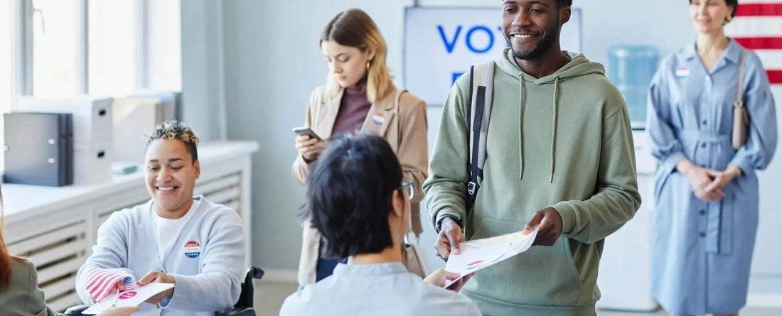 image of poll workers working on election day and people coming in to vote