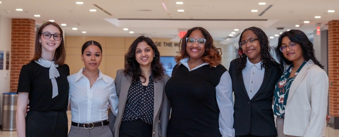 group of people standing in front of School of Public Policy logo