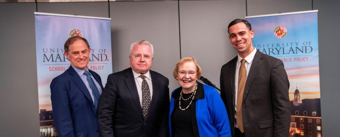 Dean Orr, Ambassador Sulluvan, Betty Duke, and Javier de Leon stand in front of UMD banners