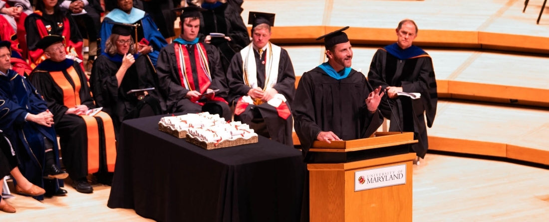 image of Ethan Brown speaking on stage at commencement