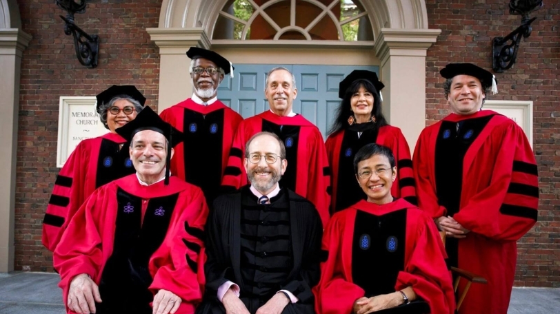Image of Jim Gates and others dressed in commencement regalia at Harvard's 2024 commencement ceremony