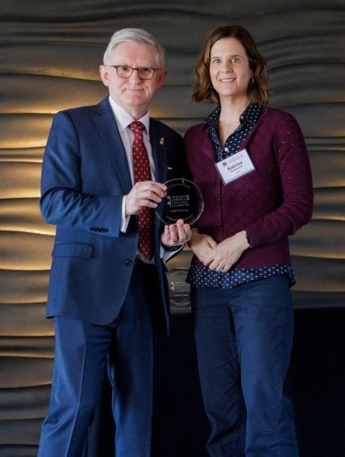 Patrick O'Shea and Katrina Walsemann pose with Walsemann's Research Excellence award