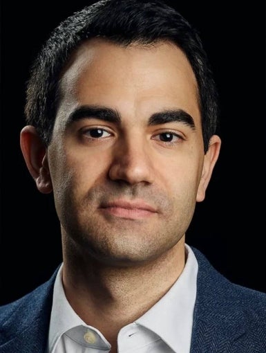 a man with dark hair and suit